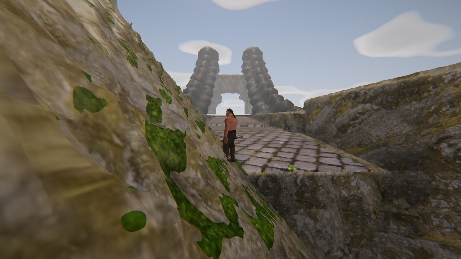 The approach: a cobbled causeway climbing between rock walls toward two towers standing against the sky, the roadway passing under the arch between them.